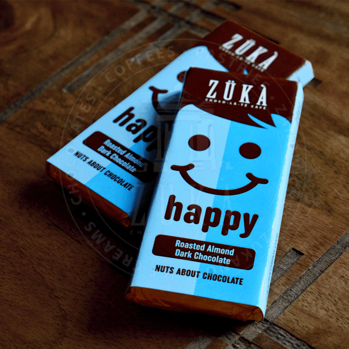 THE-HAPPY-CHOCOLATE-BAR-ROASTED-ALMOND-DARK-CHOCOLATE.png The Happy Chocolate Bar